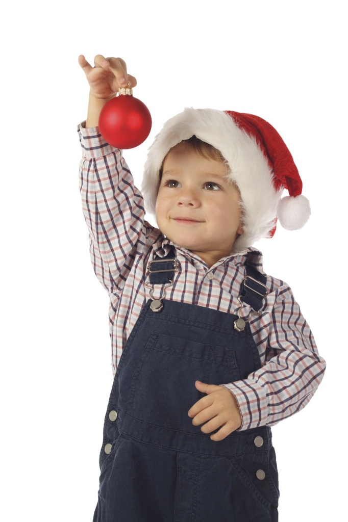 Smiling little boy with Christmas decoration, isolated on white